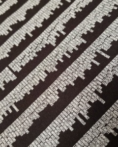 Close-up of names printed in white ink on dark marching band apparel